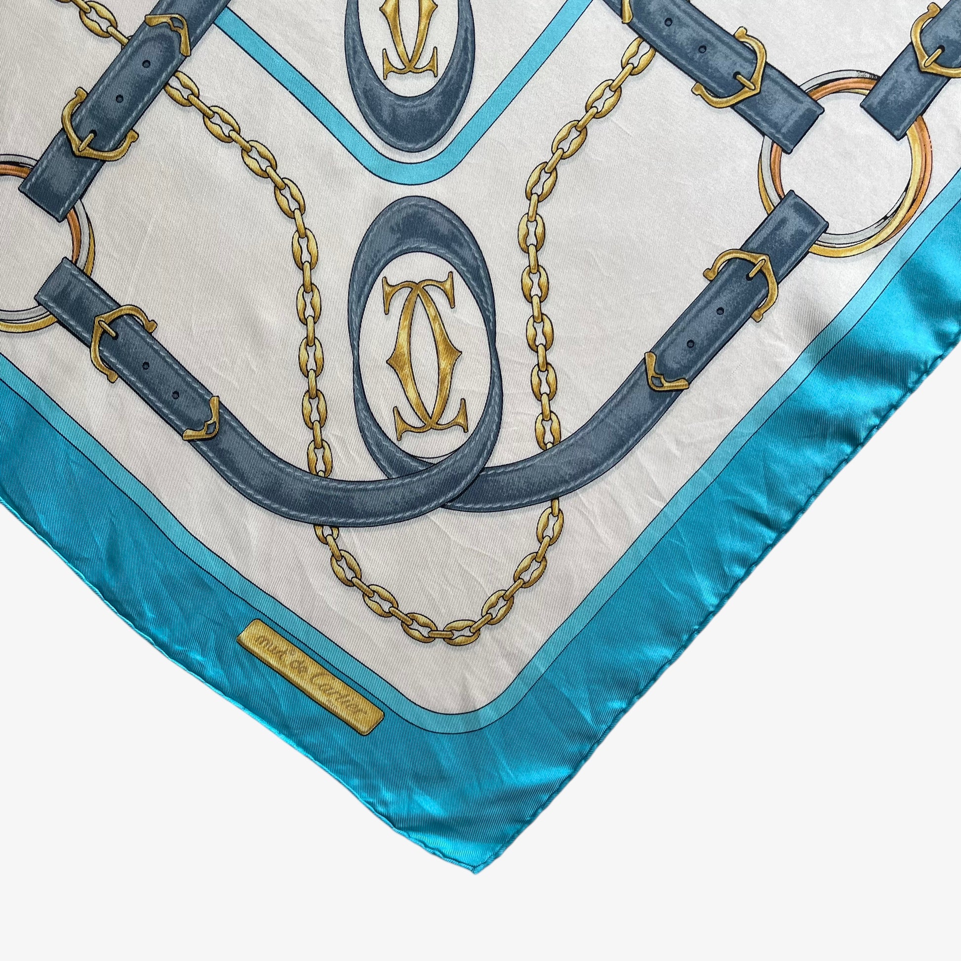 Hem of women's vintage 90s must de Cartier equestrian strap print blue silk scarf featuring the classic CC logo.