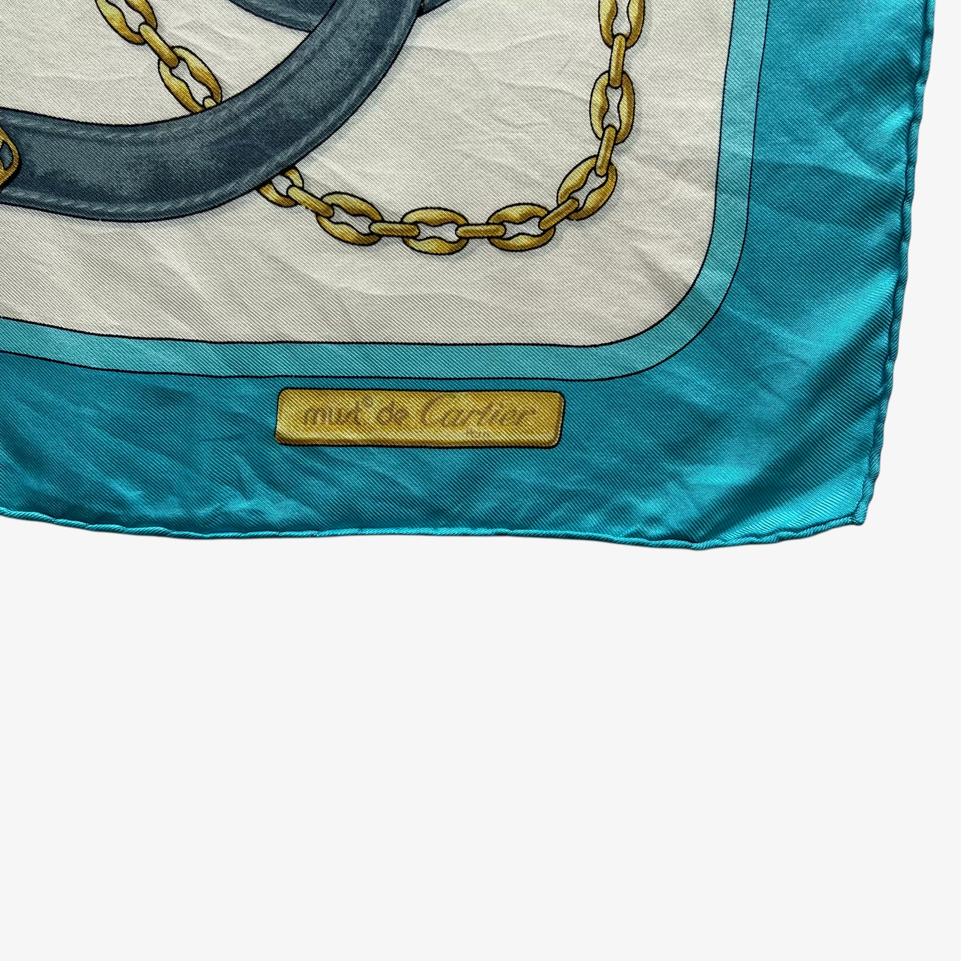 Must de Cartier spell out logo on women's vintage 90s equestrian strap print blue silk scarf featuring the classic CC logo.