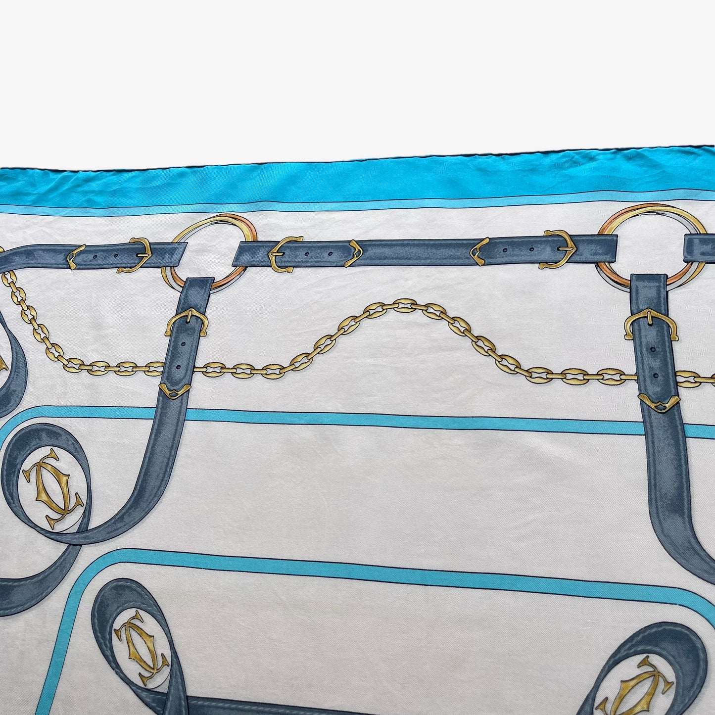 Equestrian strap pattern on women's vintage 90s must de Cartier blue silk scarf featuring the classic CC logo.