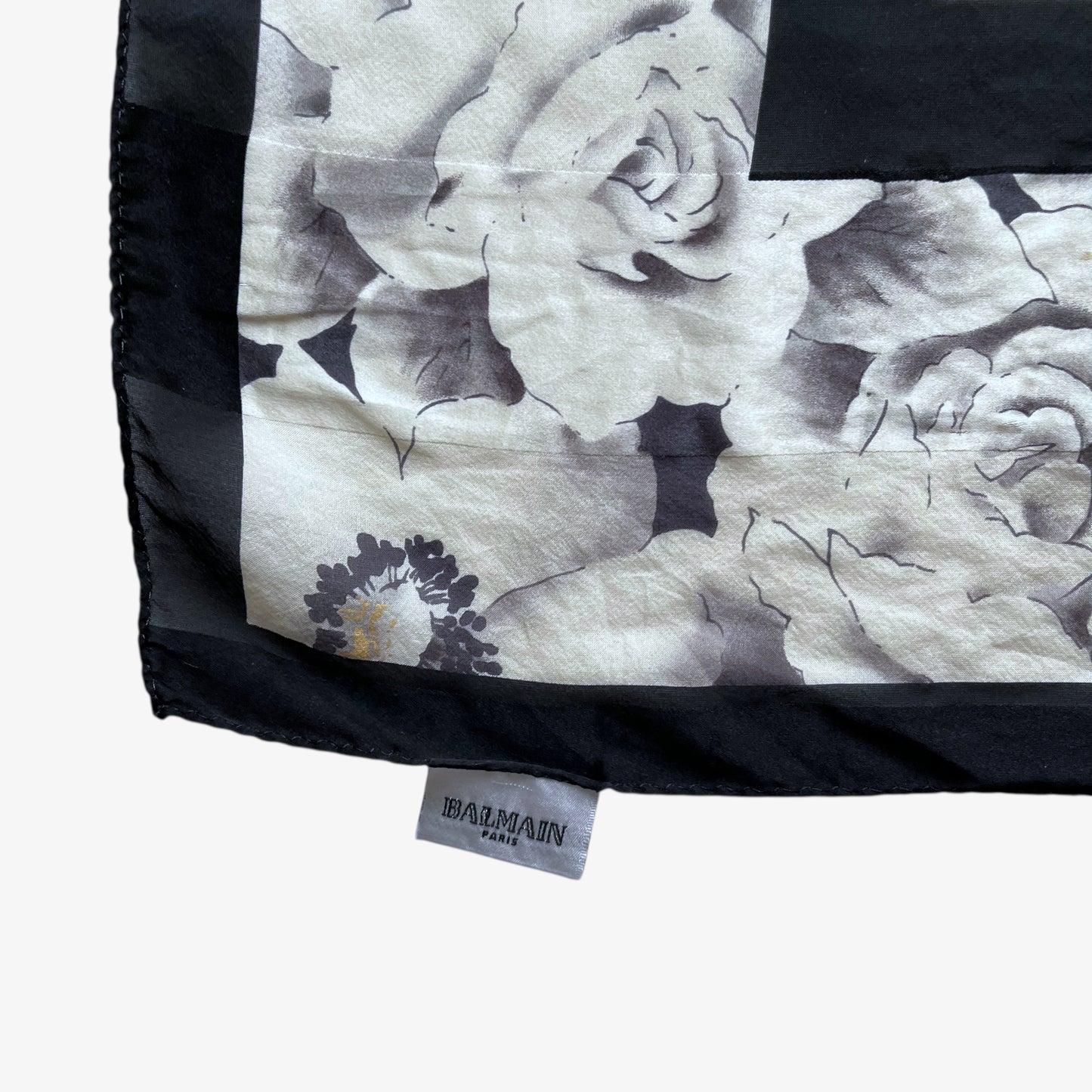Balmain Paris label on women's vintage 90s all over floral print silk scarf.