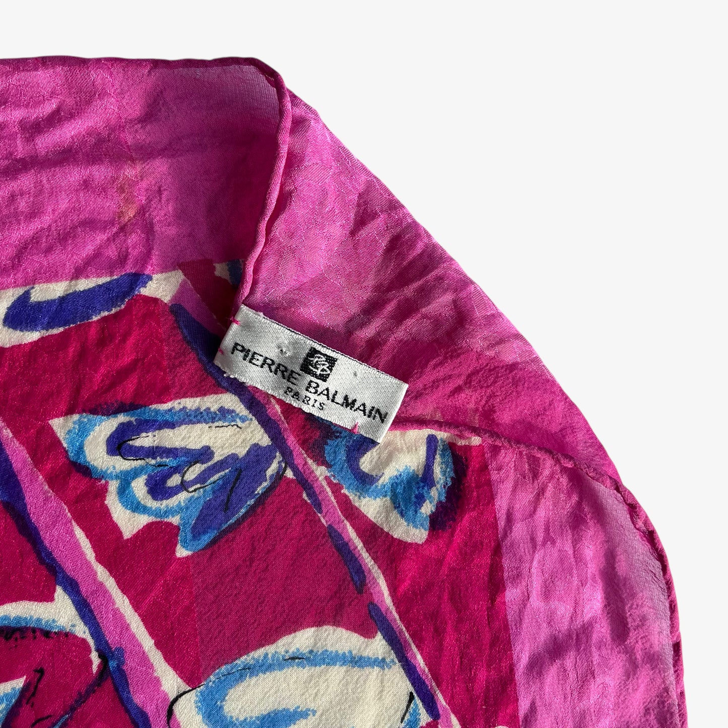 Pierre Balmain Paris label on women's vintage 90s pink silk scarf features a colourful abstract floral print.
