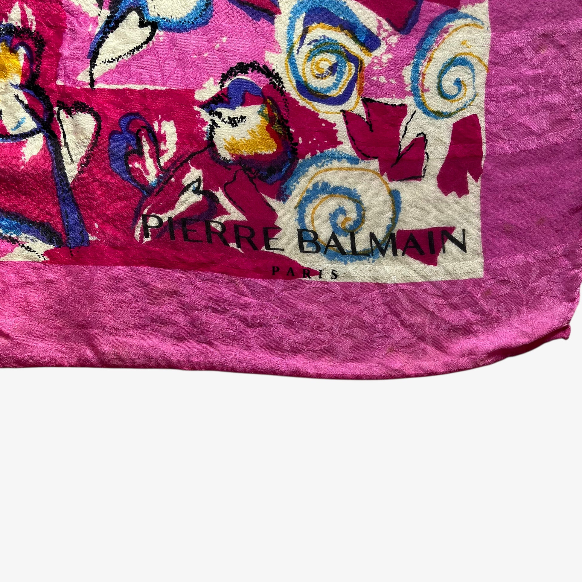 Pierre Balmain Paris spell out logo on women's vintage 90s Pierre Balmain Paris pink silk scarf features a colourful abstract floral print.
