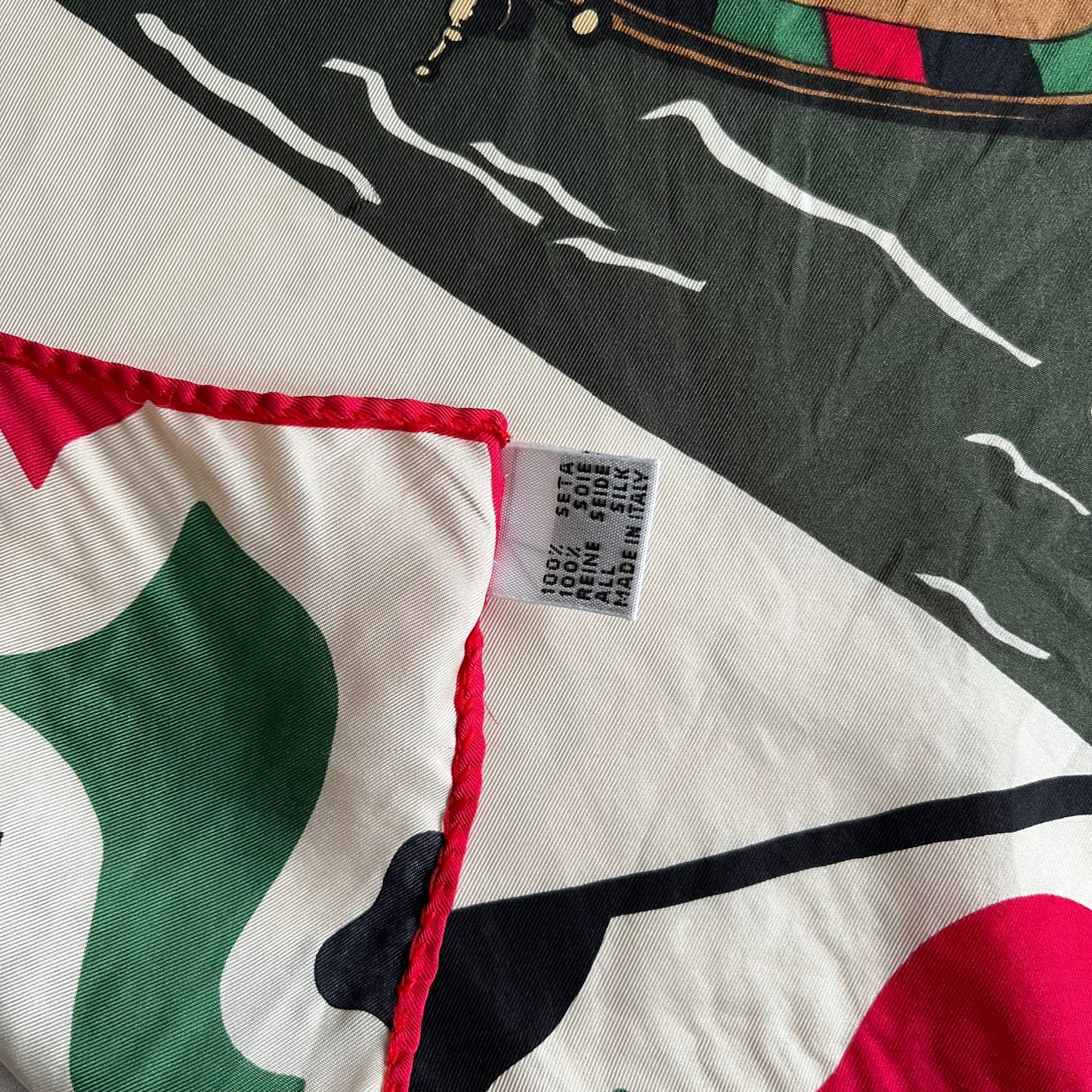 Made in Italy label of vintage 90s women's Pierre Balmain Paris Peugeot 306 promotional print silk scarf with a red and green racing stripe design.