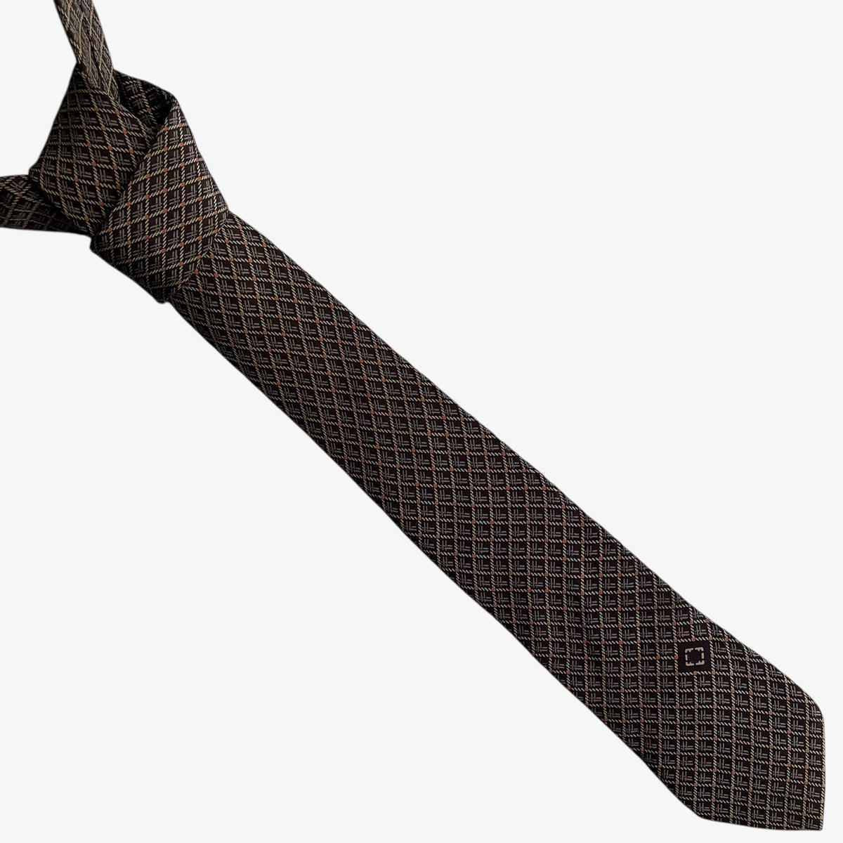 Vintage 90s Salvatore Ferragamo geometric abstract F initial print brown silk tie on a white background.