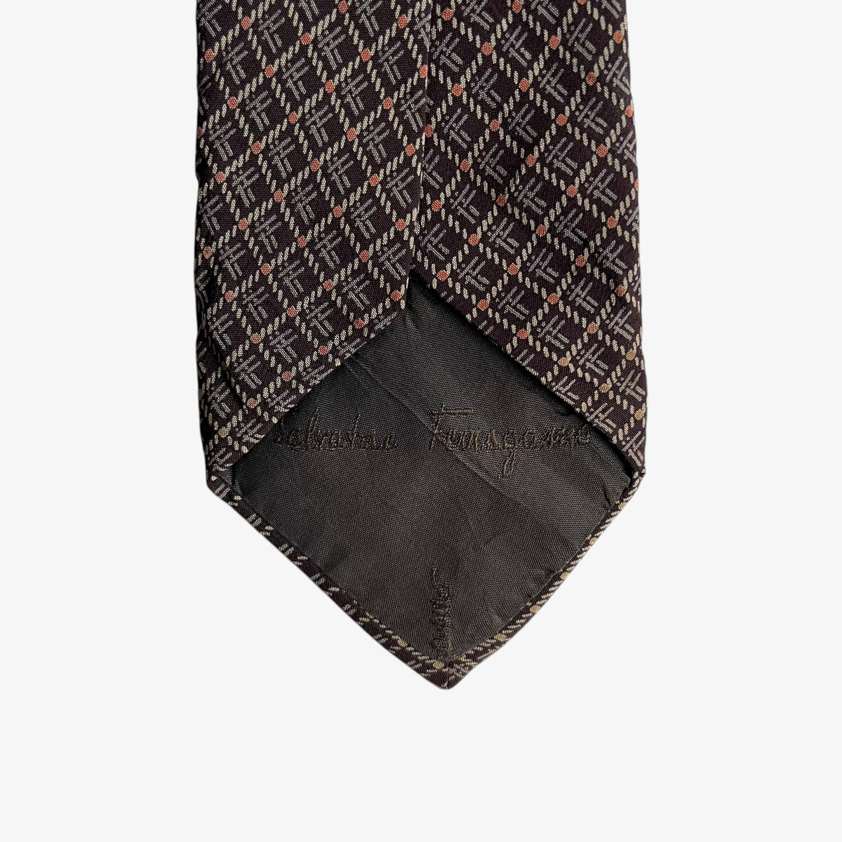 Salvatore Ferragamo logo print on the back of a vintage 90s geometric abstract print brown silk tie.
