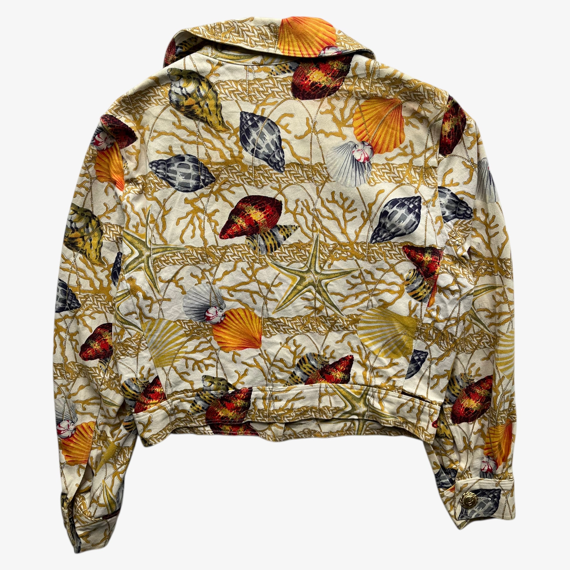 Back of vintage 90s women's Christian Llinares CL2 nautical seashell print gold trucker jacket.