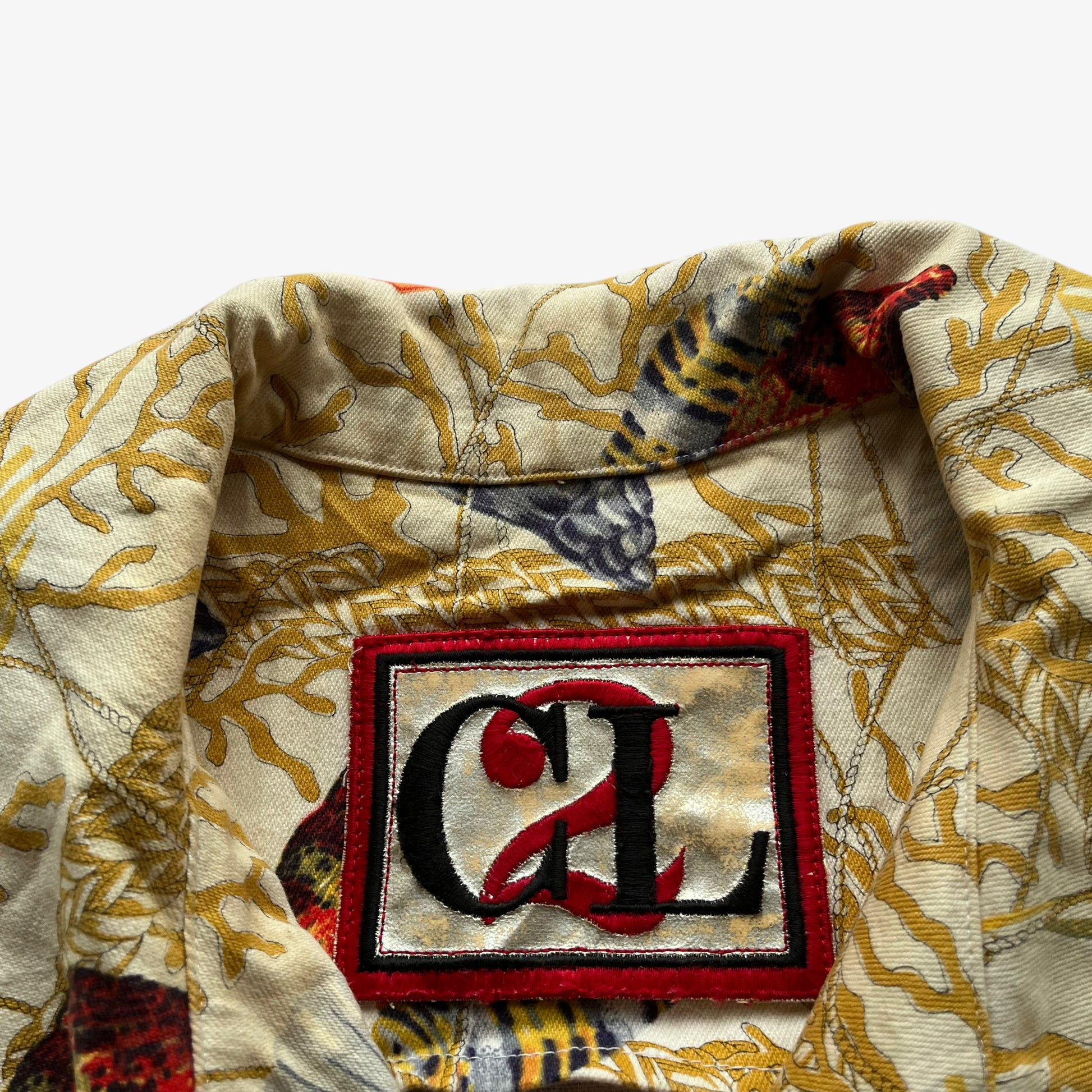 CL2 label of vintage 90s women's Christian Llinares nautical seashell print gold trucker jacket.