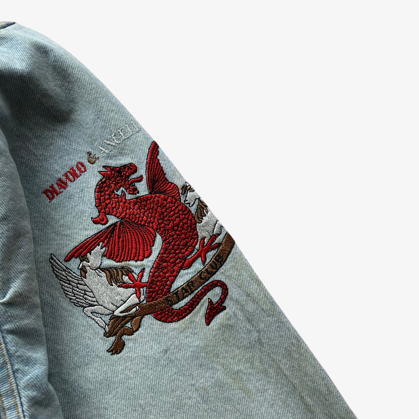 Embroidered dragon on vintage 90s women's Diavolo and Angeli star club blue denim jacket.