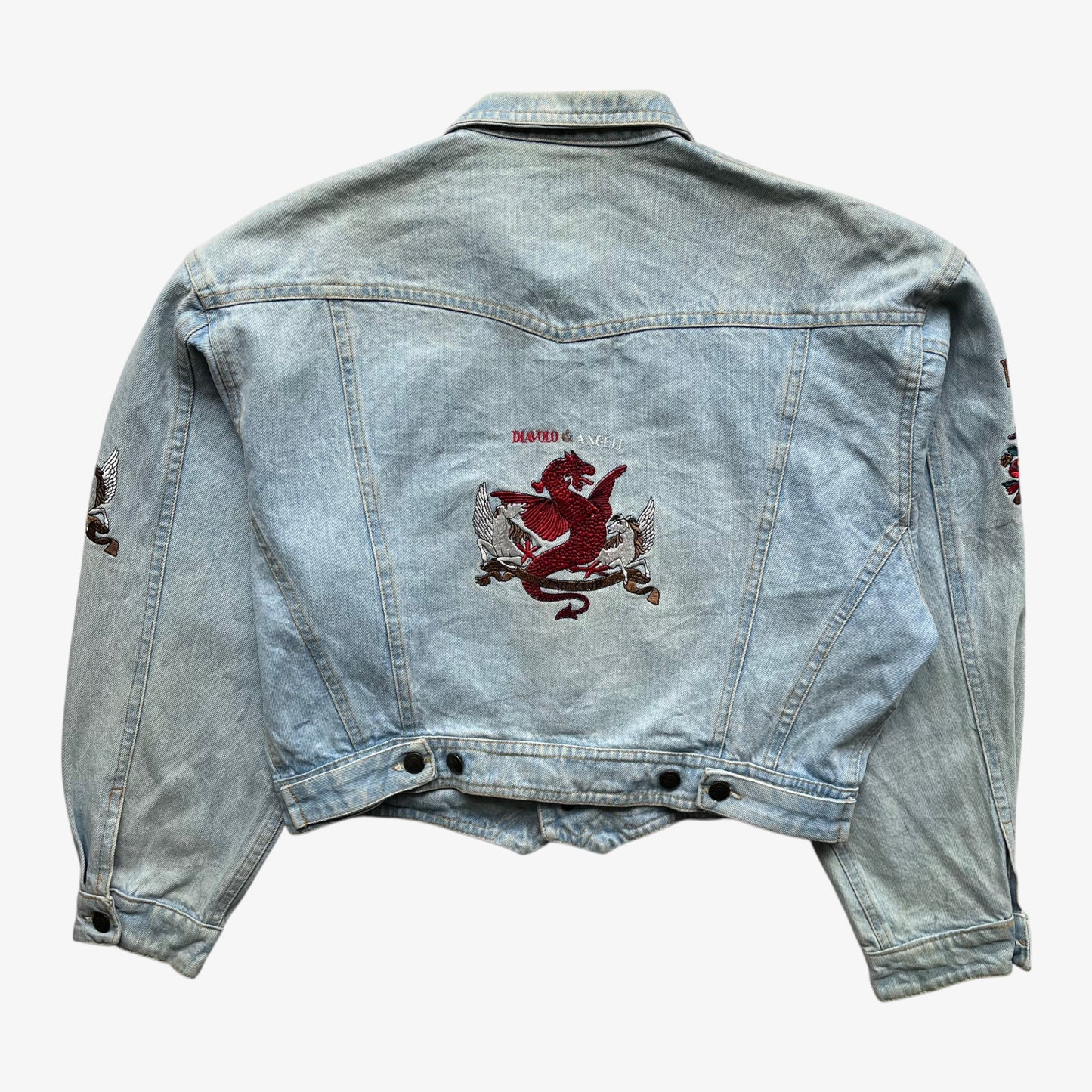 Back of vintage 90s women's Diavolo and Angeli star club blue denim jacket with embroidered dragon.