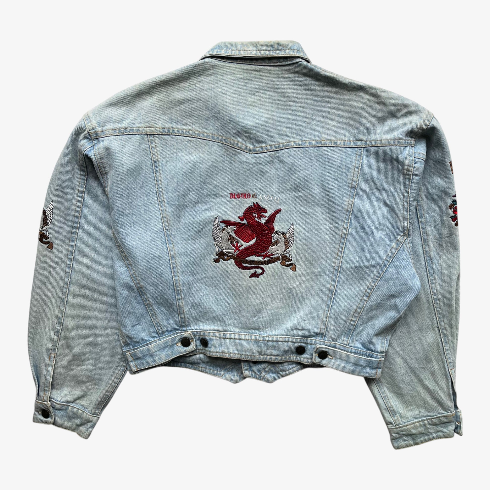 Back of vintage 90s women's Diavolo and Angeli star club blue denim jacket with embroidered dragon.