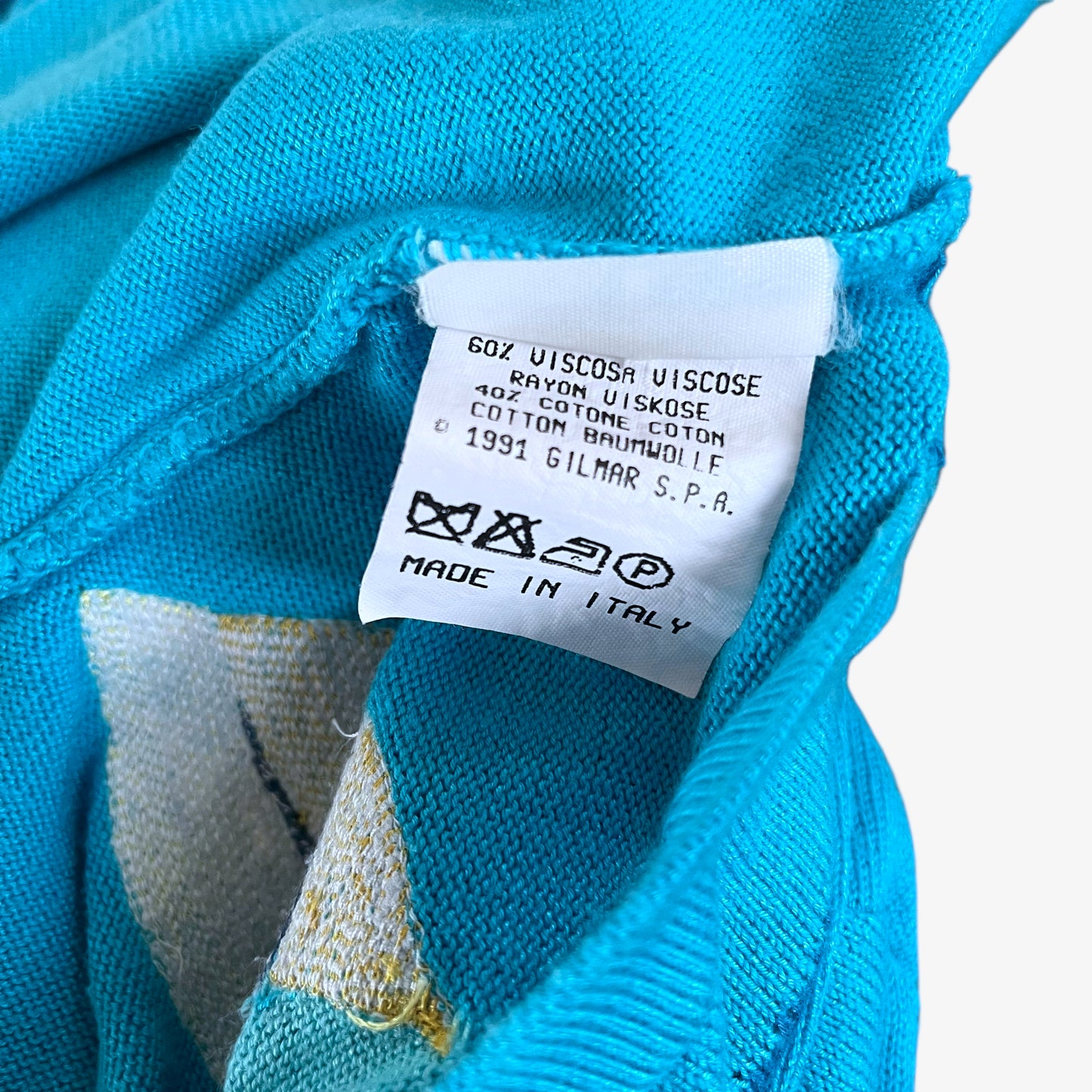 Inside label of vintage 1991 ICEBERG women’s blue knitted Disney jumper.