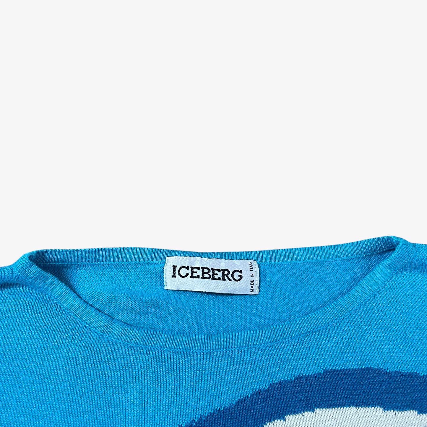 Label of vintage 90s ICEBERG women’s blue knitted Disney jumper.
