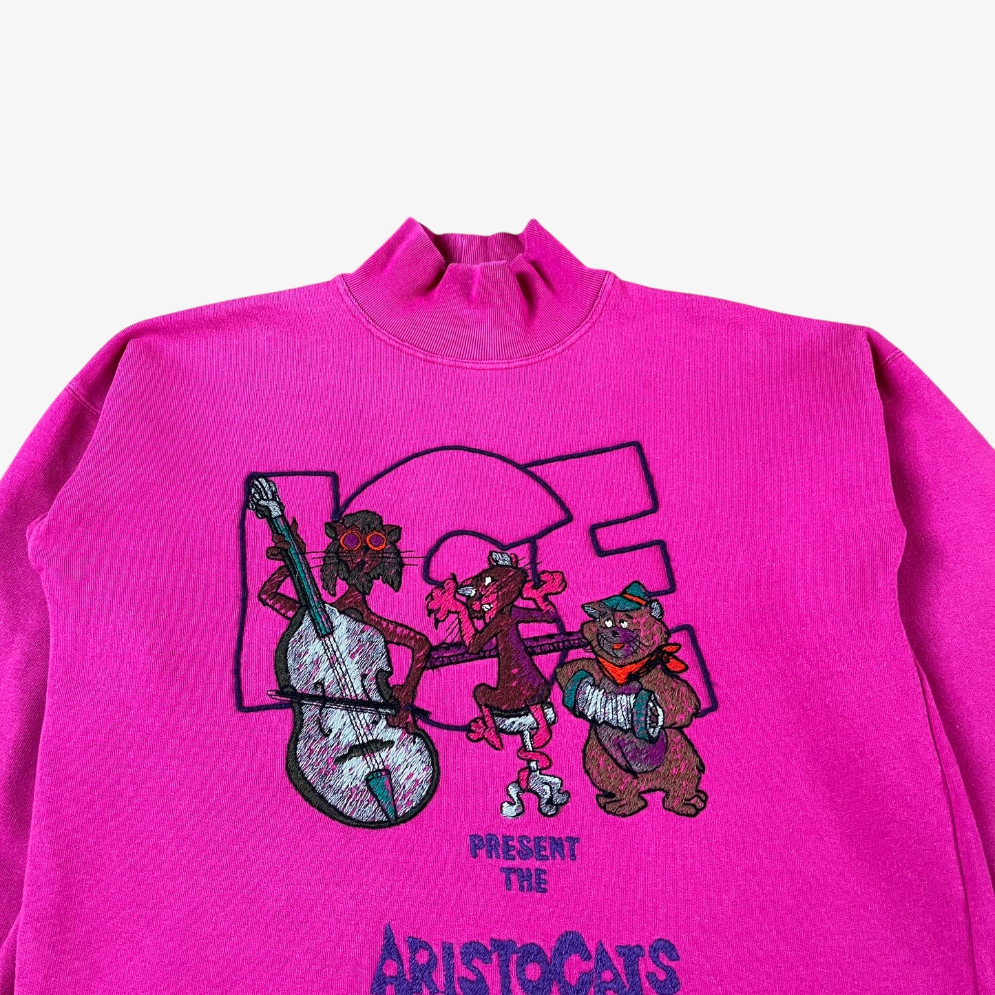 Close up of vintage 90s ICEBERG Disney Aristocats women’s pink turtleneck sweatshirt.