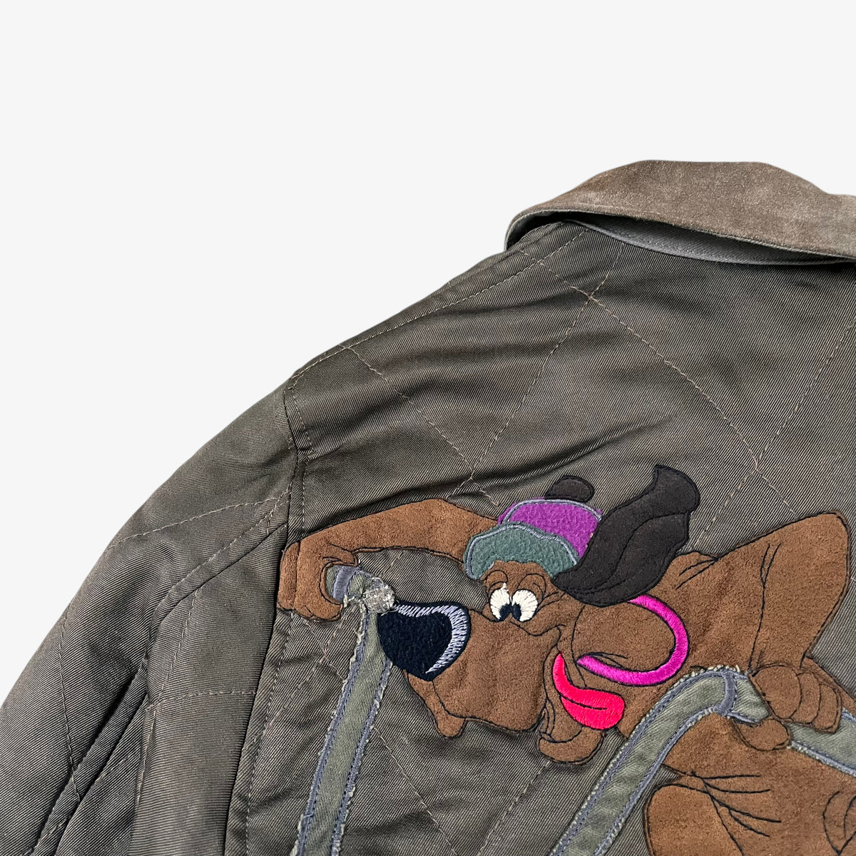 Wear to embroidery of Disney Aristocats embroidery on vintage 90s Iceberg women’s khaki quilted bomber jacket.