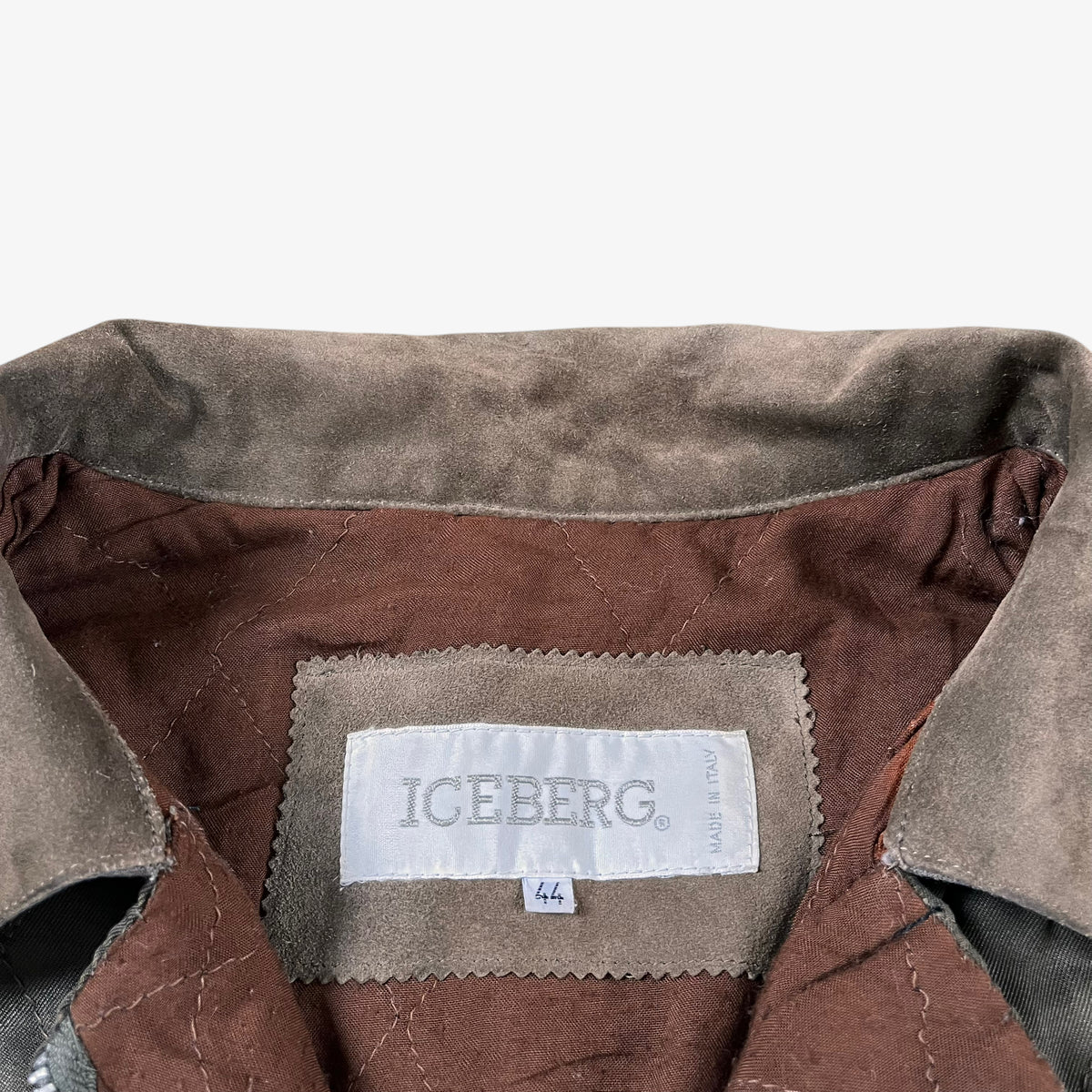 Label of vintage 90s Iceberg women’s khaki quilted bomber jacket.