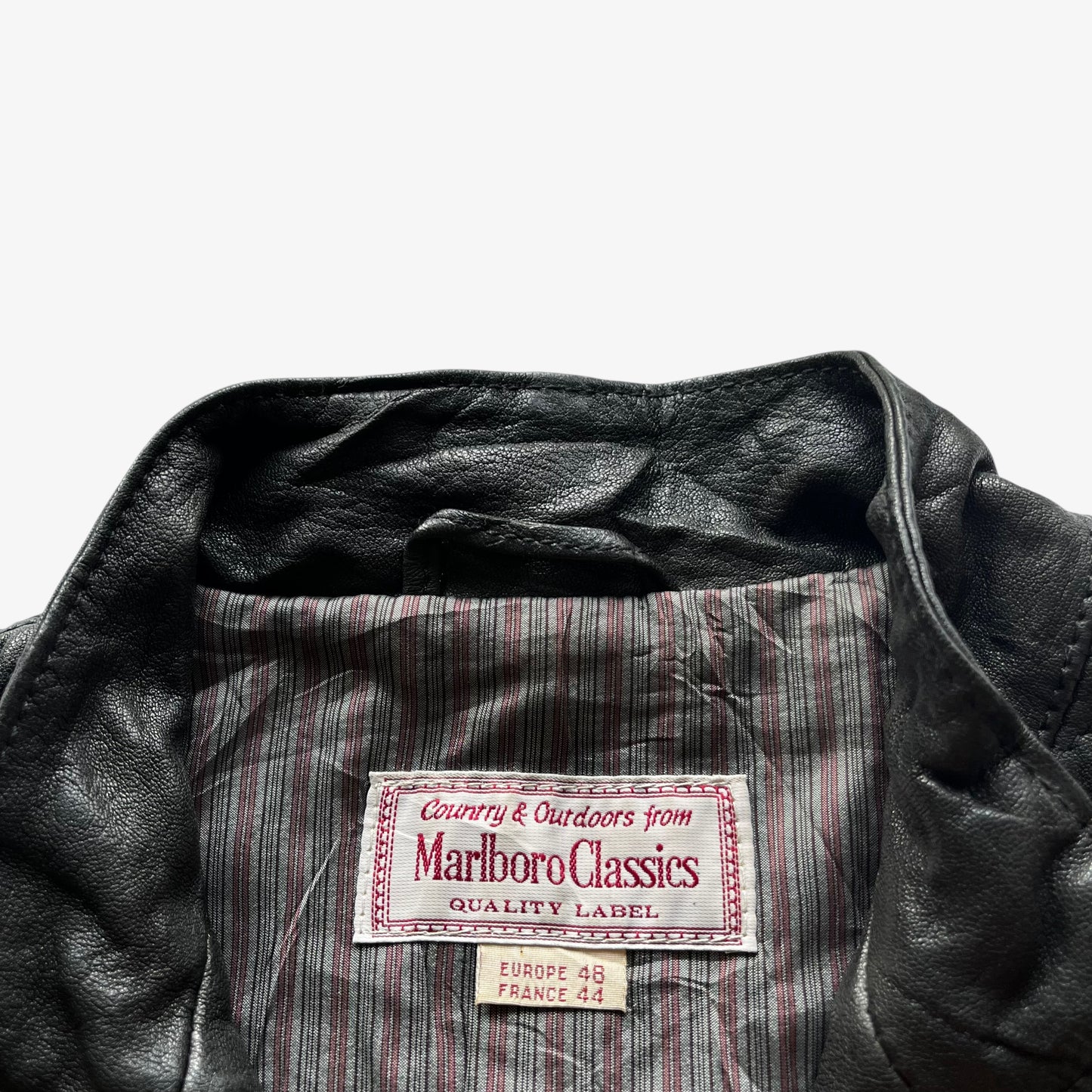 Vintage 90s Marlboro Classics label inside the neck seam of a women's black quilted leather biker jacket.