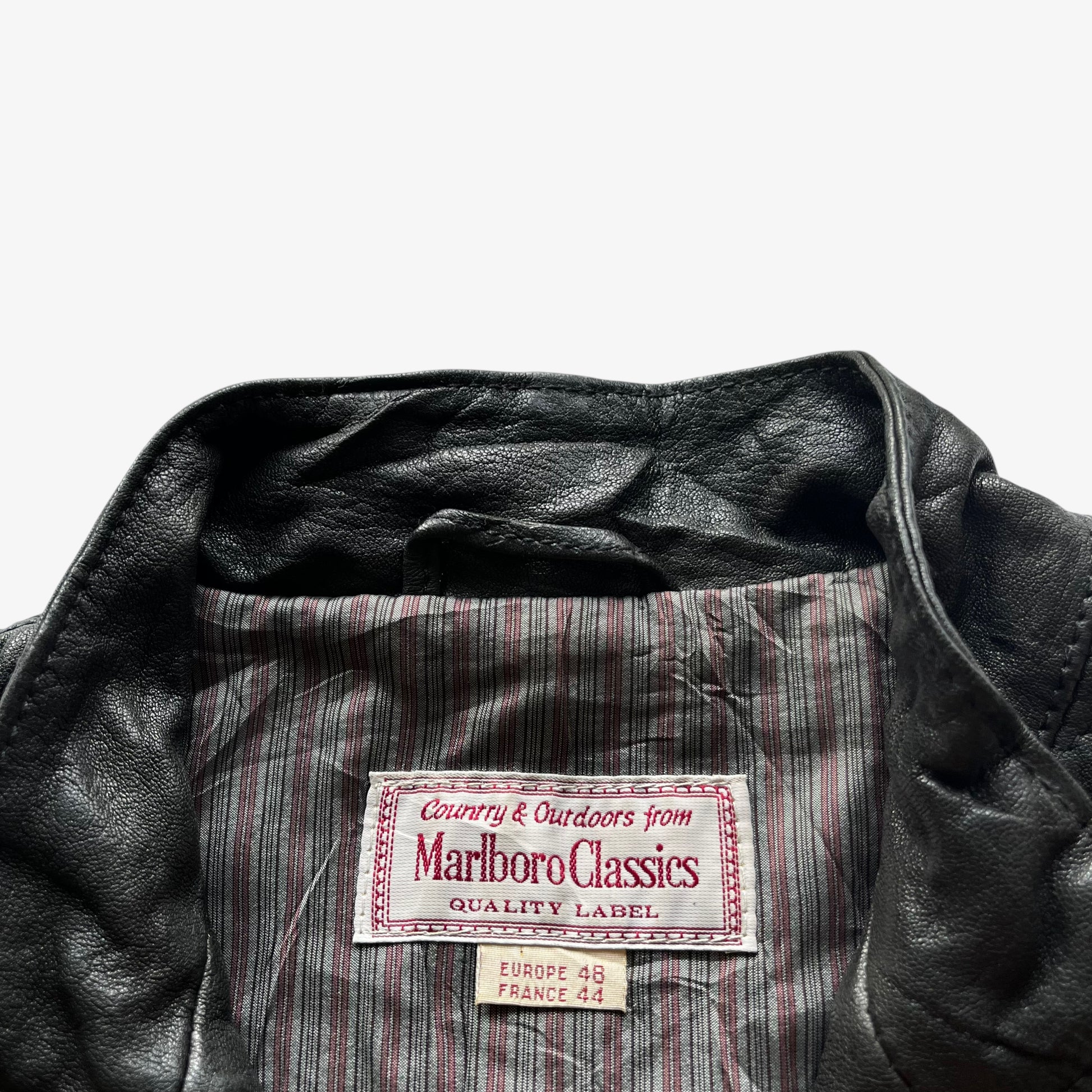 Vintage 90s Marlboro Classics label inside the neck seam of a women's black quilted leather biker jacket.