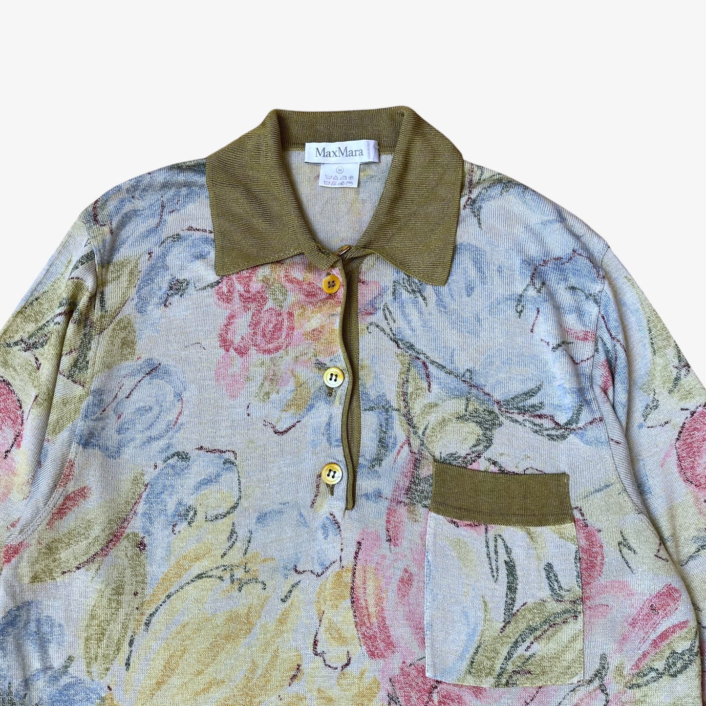Close up of floral watercolour pattern on a vintage 90s women's Max Mara knitted shirt with green contrasting collar.