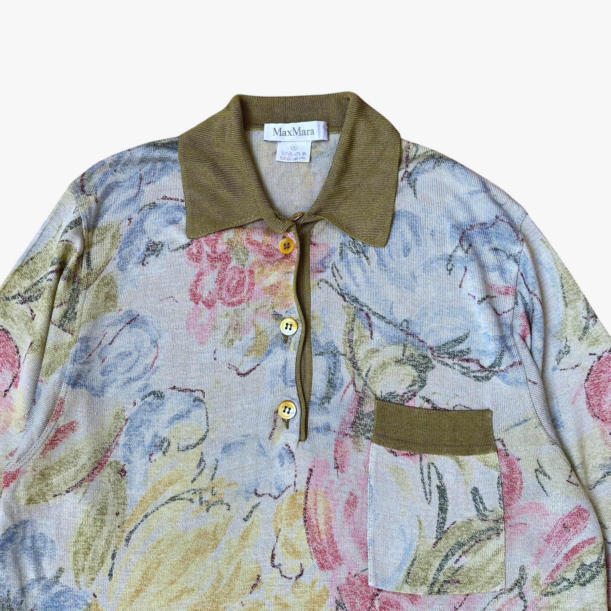 Close up of floral watercolour pattern on a vintage 90s women's Max Mara knitted shirt with green contrasting collar.