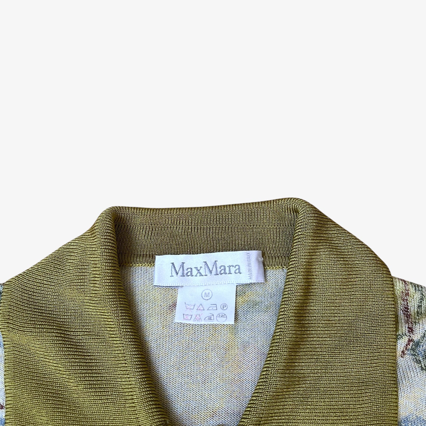 Vintage Max Mara label stitched inside of a women's floral watercolour patterned knitted shirt with green contrasting collar.