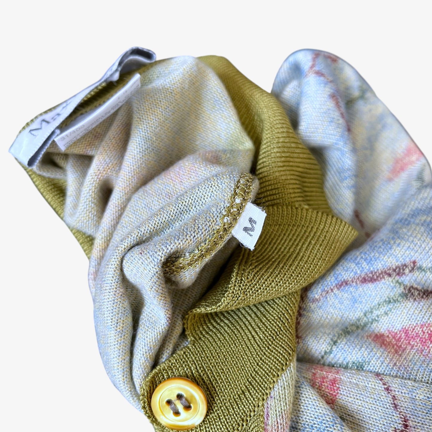 Max Mara size tag on a vintage 90s women's knitted shirt with green contrasting collar.