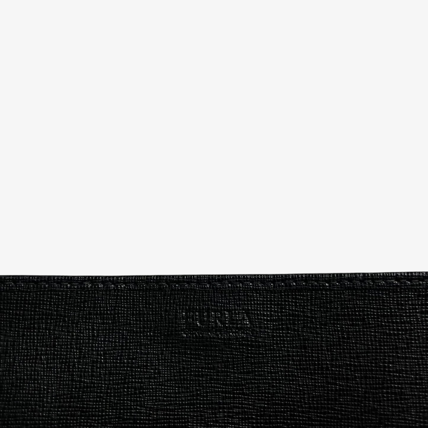 Furla embossed label on a vintage Y2K black leather continental flap wallet.
