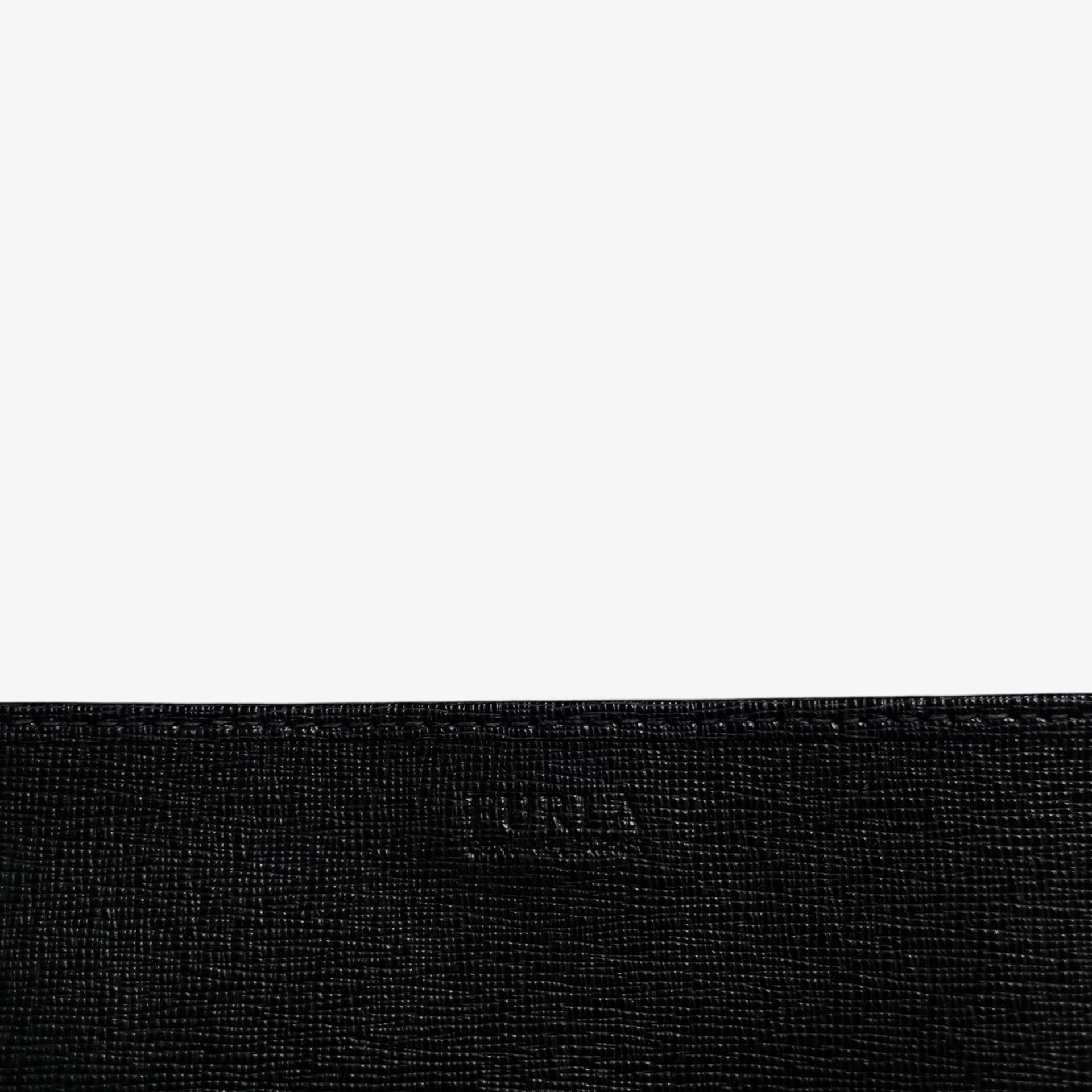 Furla embossed label on a vintage Y2K black leather continental flap wallet.