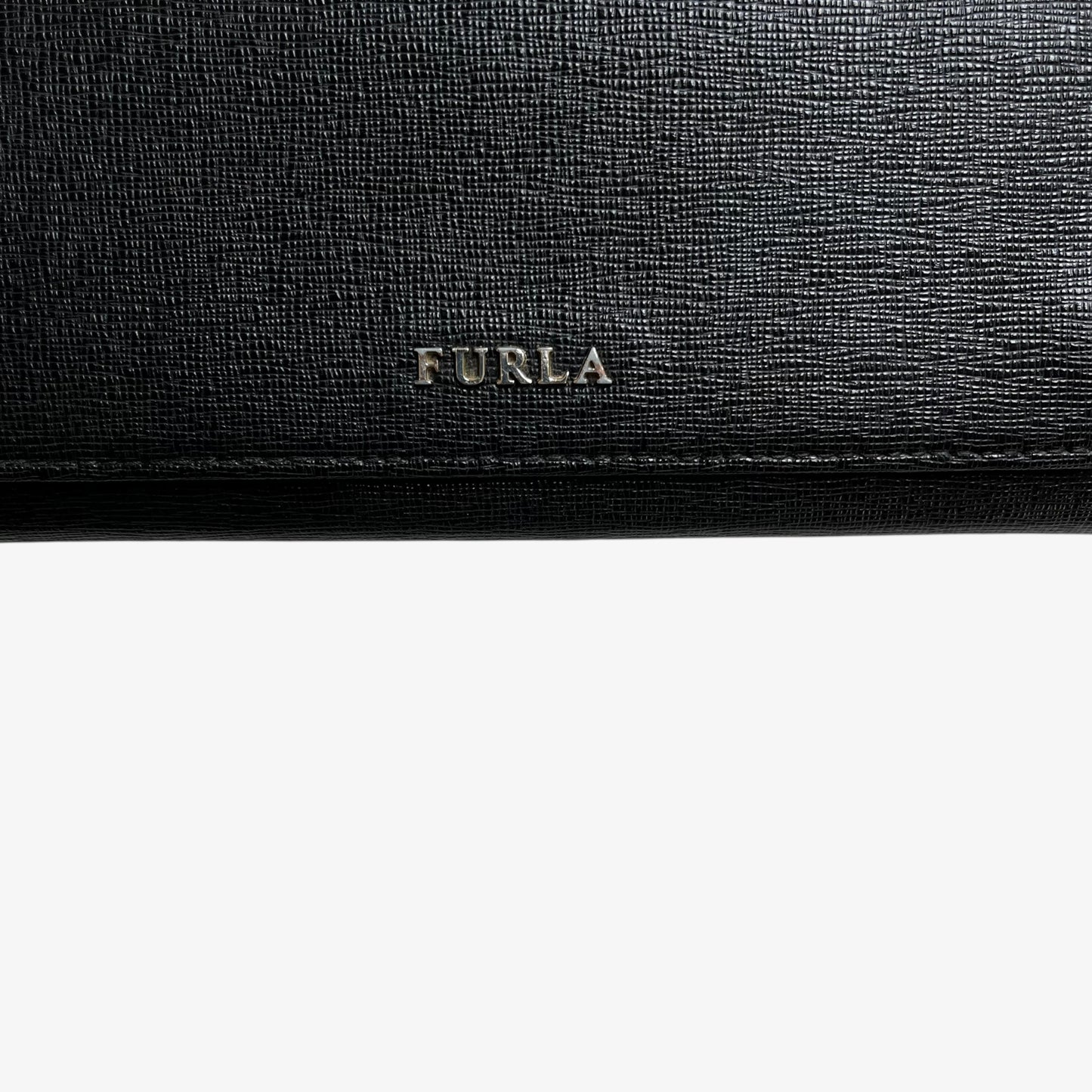 Furla logo on a vintage Y2K black leather continental flap wallet.