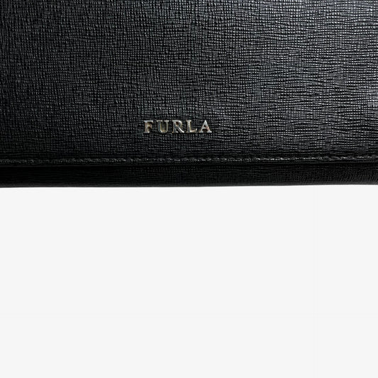 Furla logo on a vintage Y2K black leather continental flap wallet.