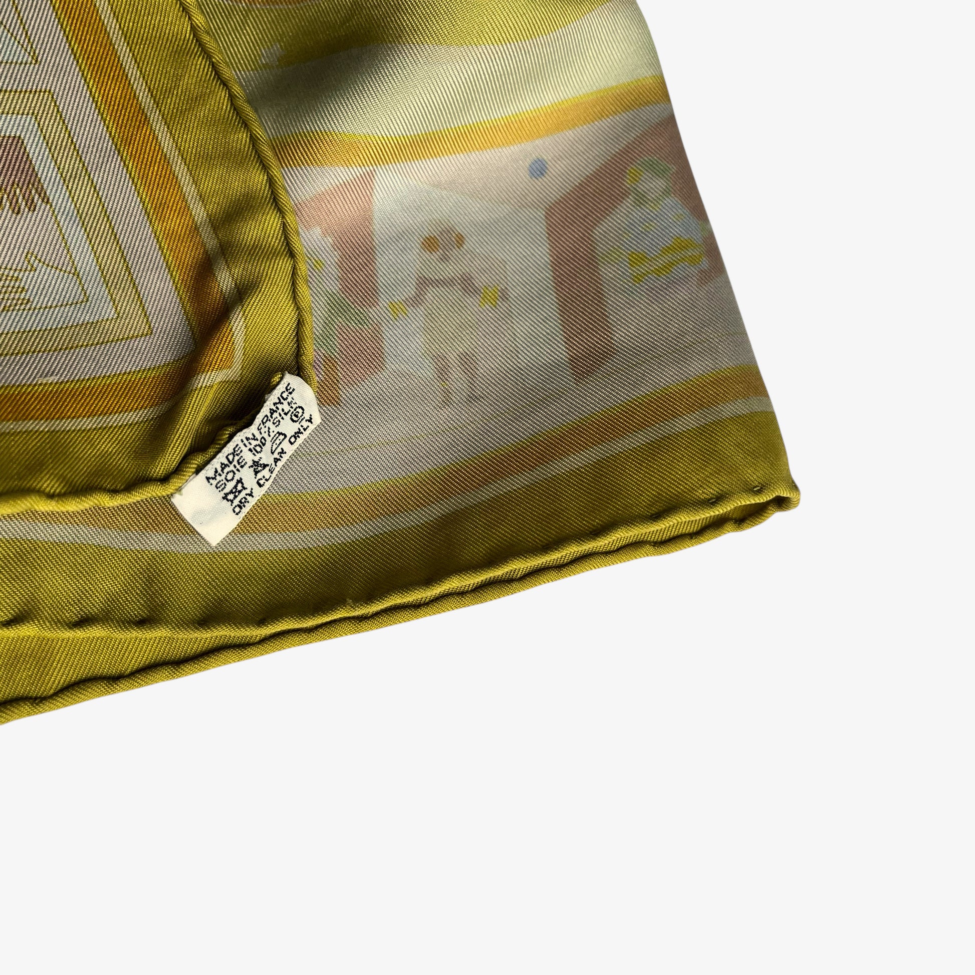 Made in France label on vintage Y2K women's Hermes Paris Donner La Main geometric sun face print yellow silk scarf.