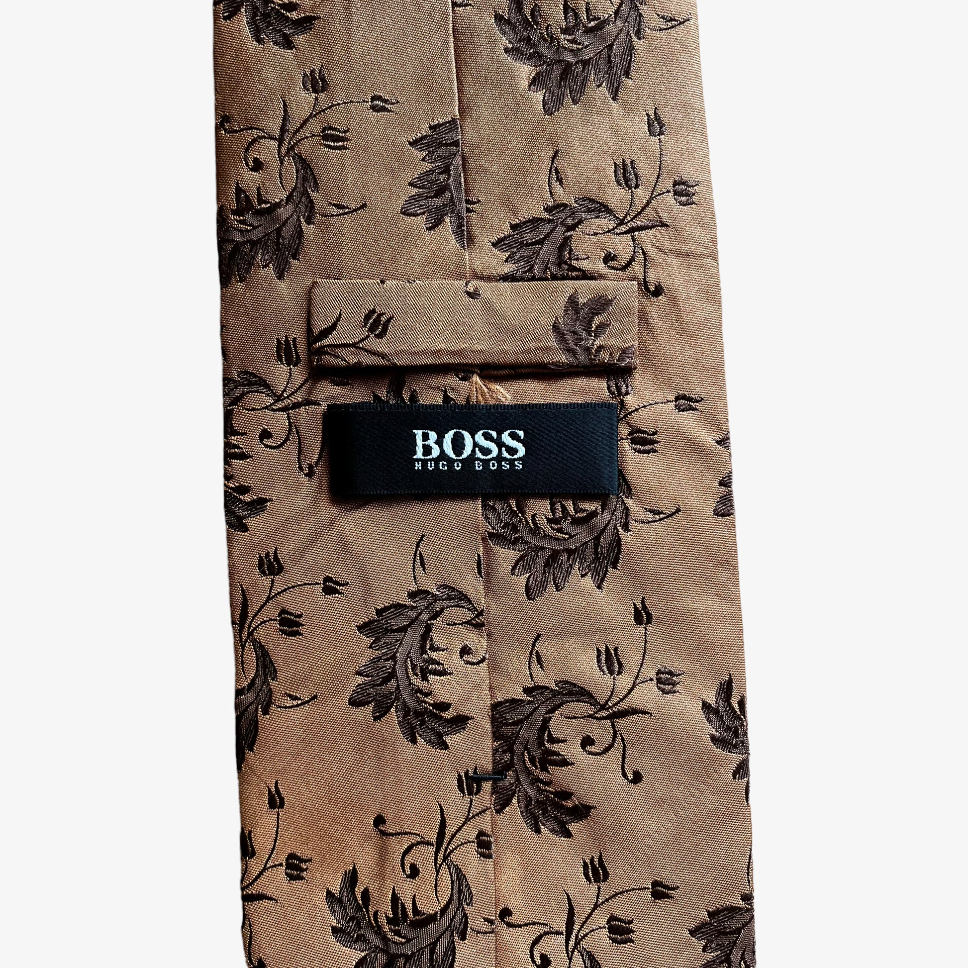 Label on vintage Y2K Hugo Boss brown silk tie features a geometric floral leaf pattern.