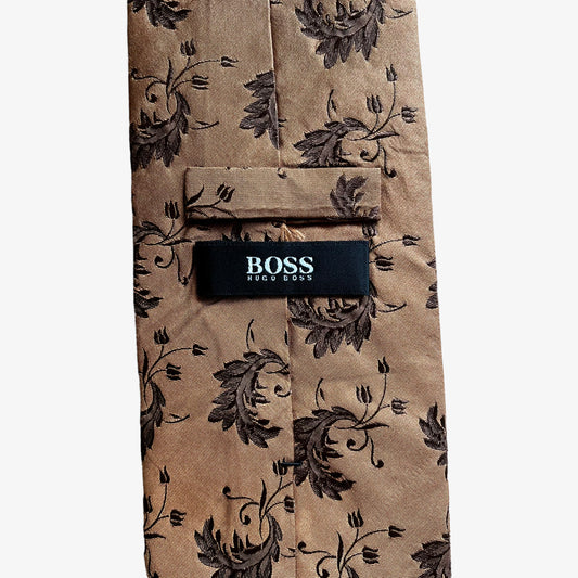 Label on vintage Y2K Hugo Boss brown silk tie features a geometric floral leaf pattern.