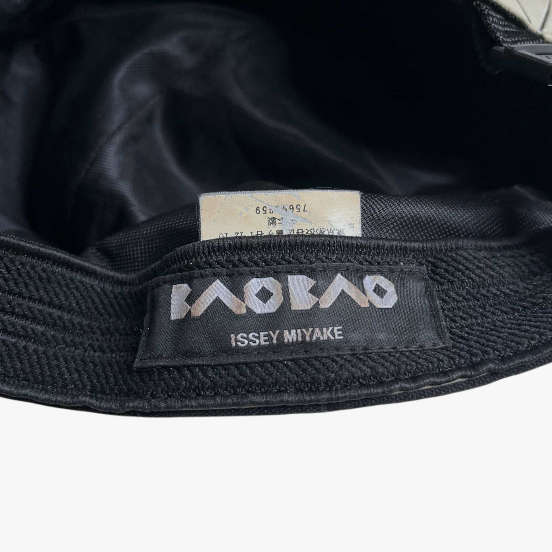 Issey Miyake bao bao label stitched inside of vintage Y2K beige geometric cap.