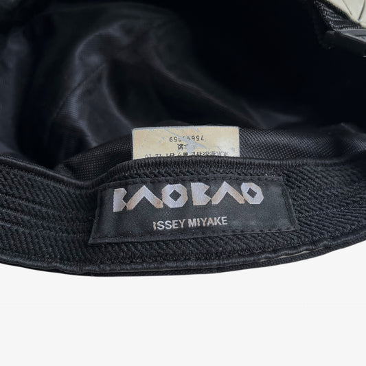 Issey Miyake bao bao label stitched inside of vintage Y2K beige geometric cap.