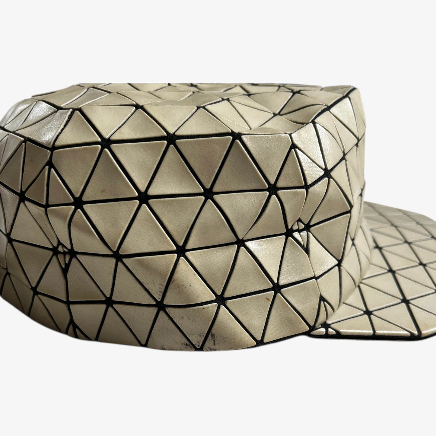 Patina on vintage Y2K Issey Miyake bao bao beige geometric cap.