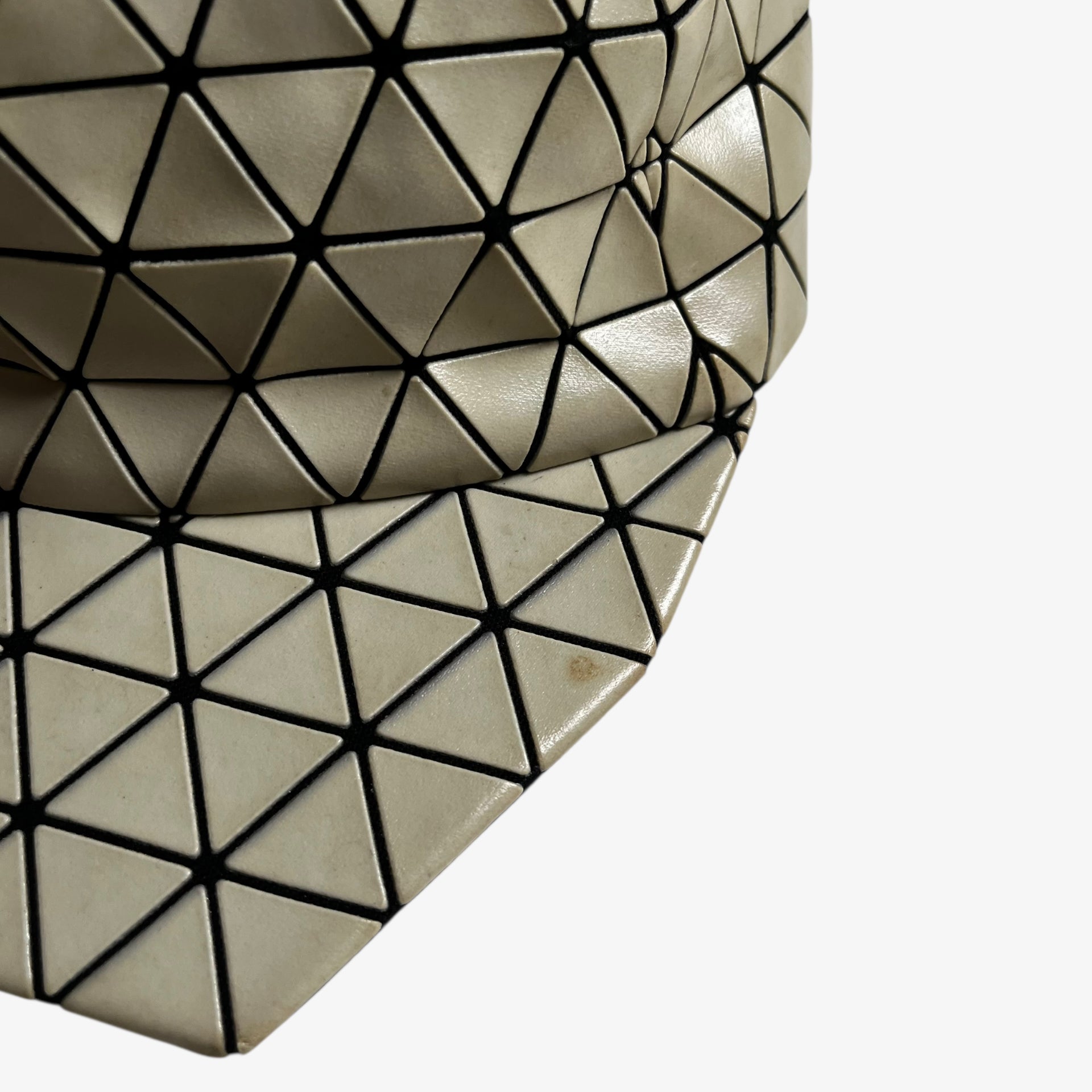 Wear on the side of vintage Y2K Issey Miyake bao bao beige geometric cap.