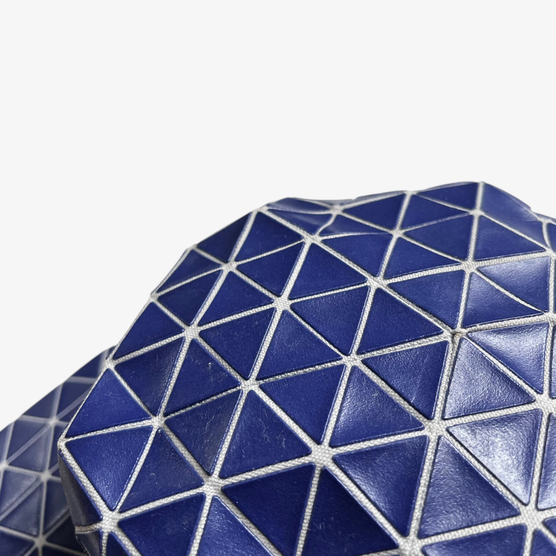 Wear on vintage Y2K Issey Miyake bao bao blue geometric cap.