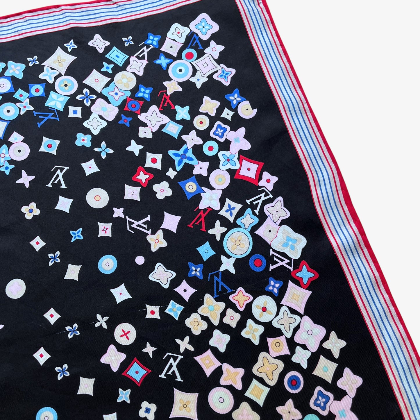 General patina of a vintage Y2K women's Louis Vuitton black silk scarf features a colourful LV and abstract floral geometric print.