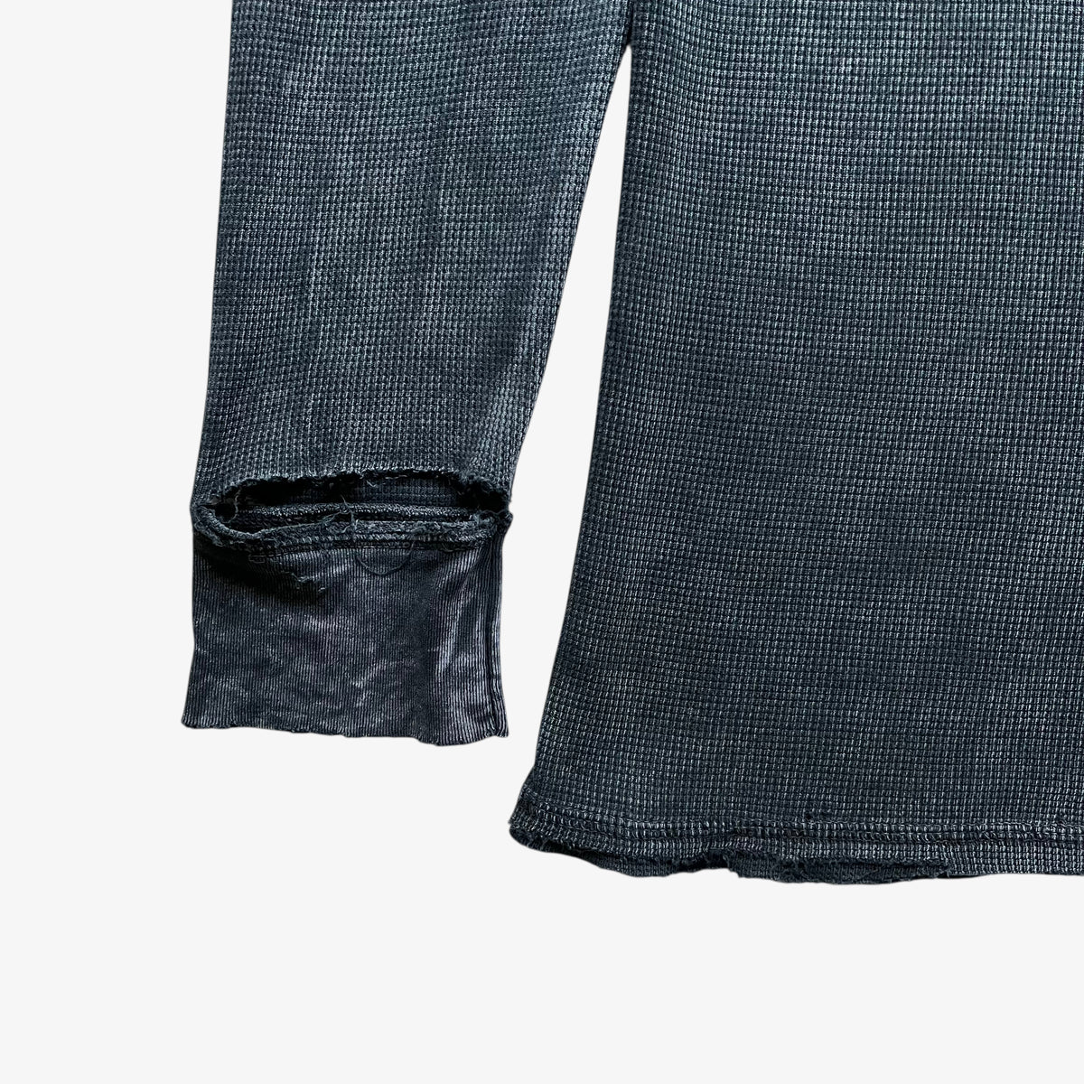 Thrashed cuff on a vintage Y2K men's textured Affliction long sleeve faded navy t-shirt.
