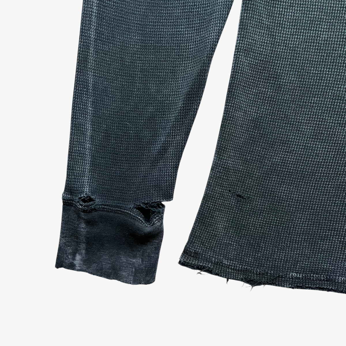 Wear on the cuff of vintage Y2K men's textured Affliction long sleeve faded navy thrashed t-shirt.