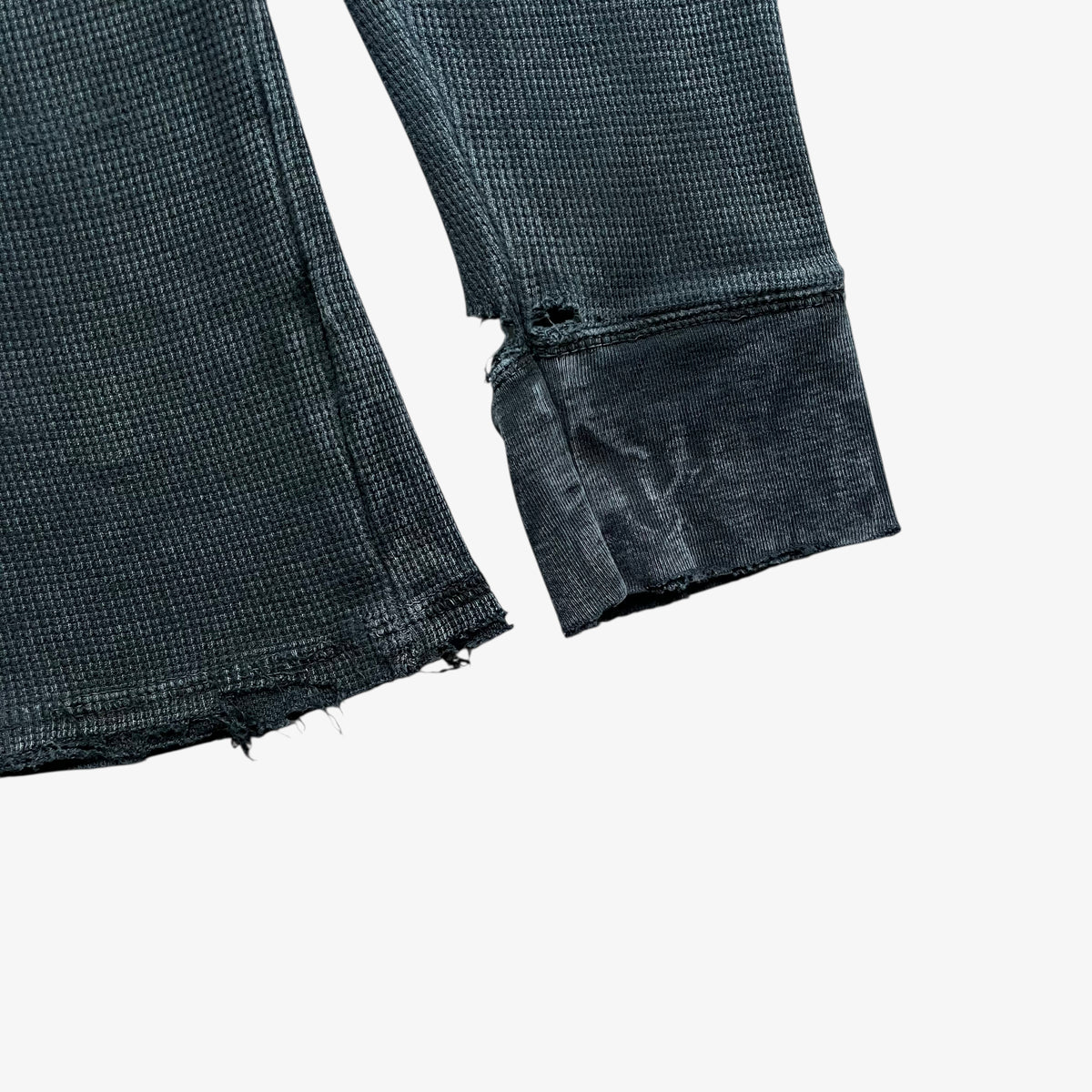 Thrashed hem of a vintage Y2K men's textured Affliction long sleeve faded navy t-shirt.