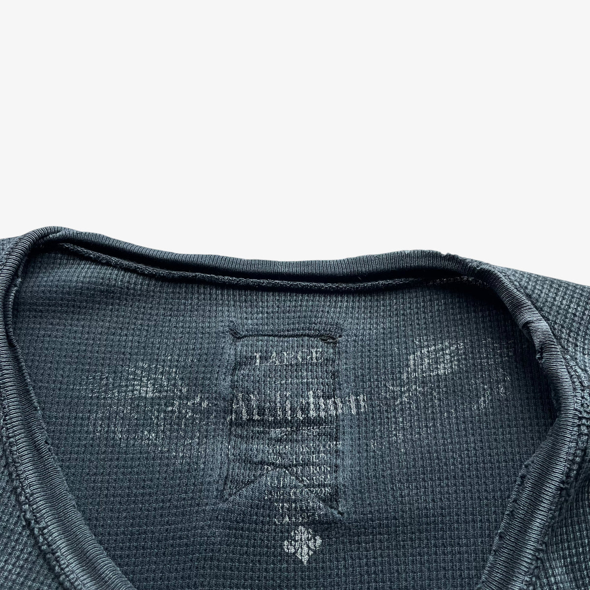 Printed Affliction label inside of a vintage Y2K men's textured long sleeve faded navy thrashed t-shirt.