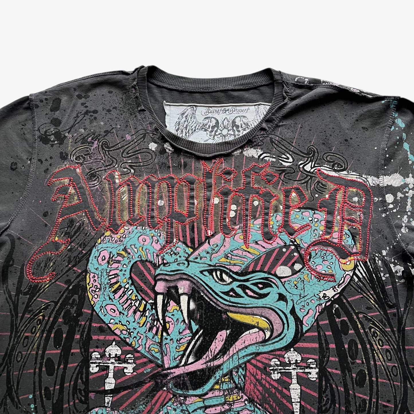 Close up of Amplified spell out and snake graphic on a men's grey vintage t-shirt.