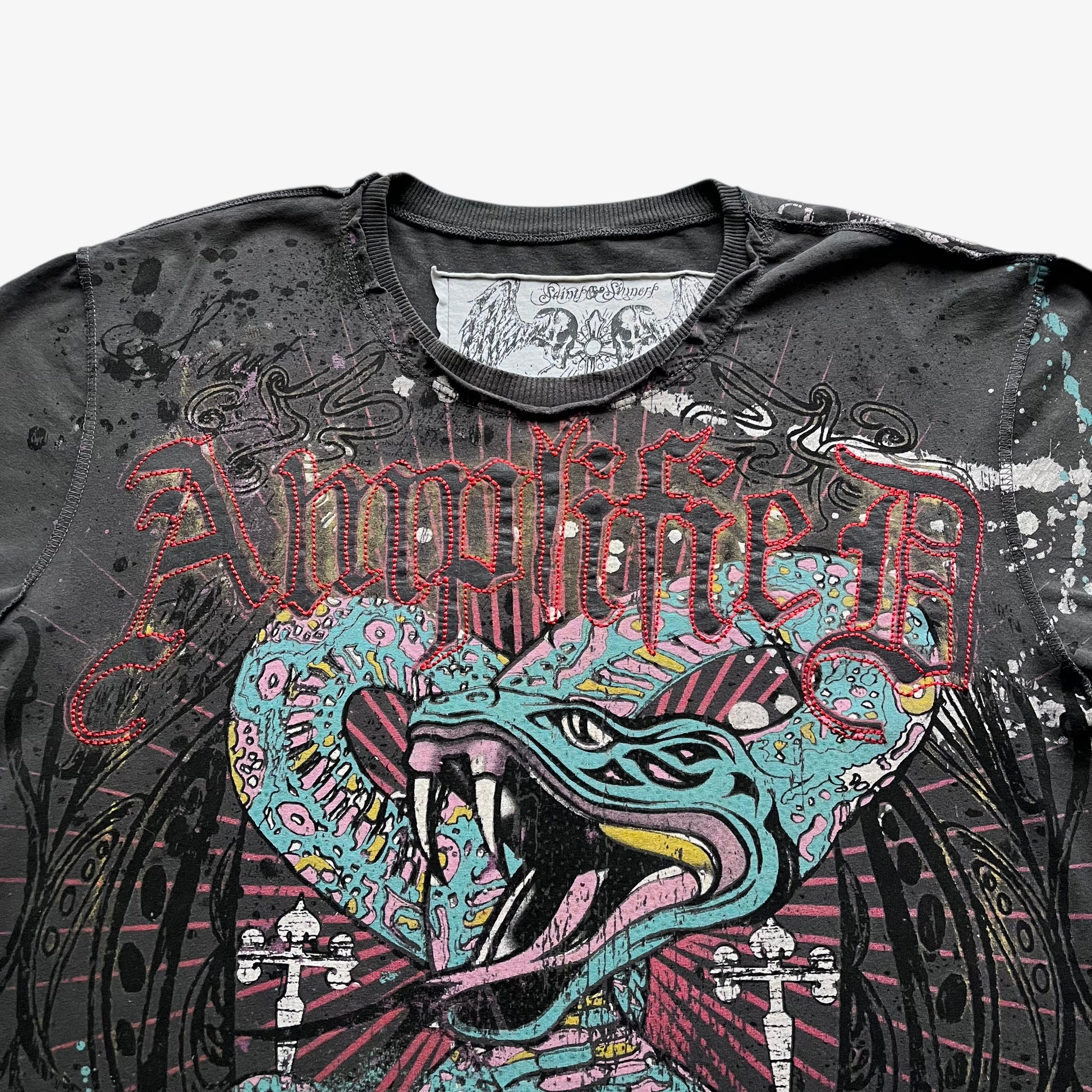 Close up of Amplified spell out and snake graphic on a men's grey vintage t-shirt.