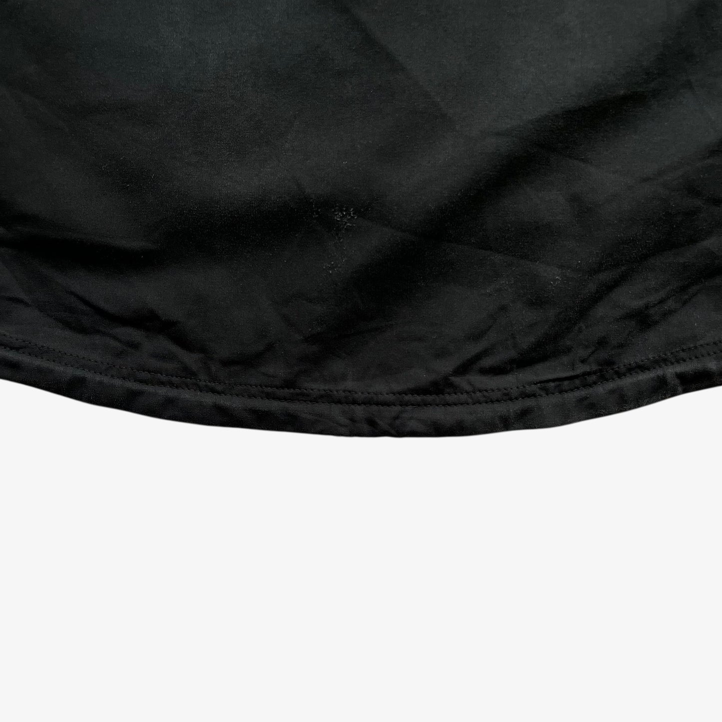 Back hem of men's vintage Y2K Arcteryx Polartec black hooded utility jacket.