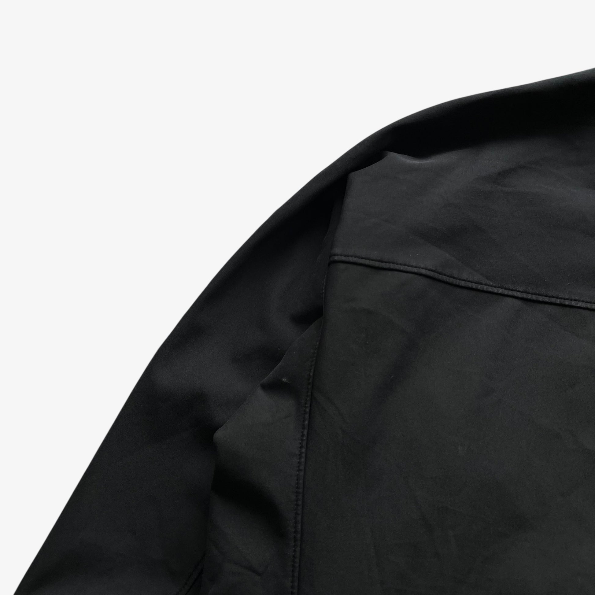 Back patina on men's vintage Y2K Arcteryx Polartec black hooded utility jacket.
