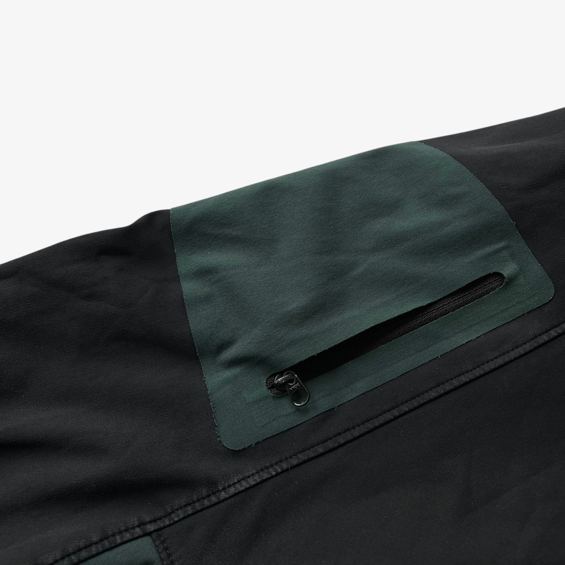 Sleeve cargo pocket of men's vintage Y2K Arcteryx Polartec black hooded utility jacket.