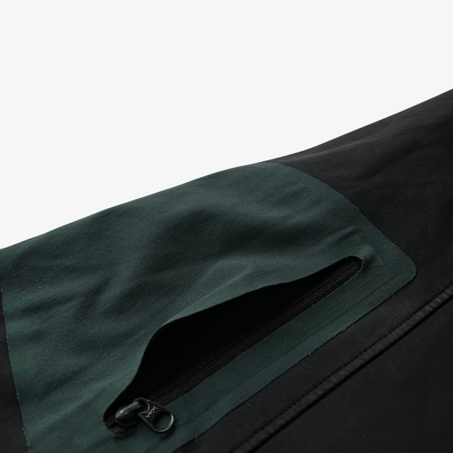 Loose lining on sleeve pocket of men's vintage Y2K Arcteryx Polartec black hooded utility jacket.