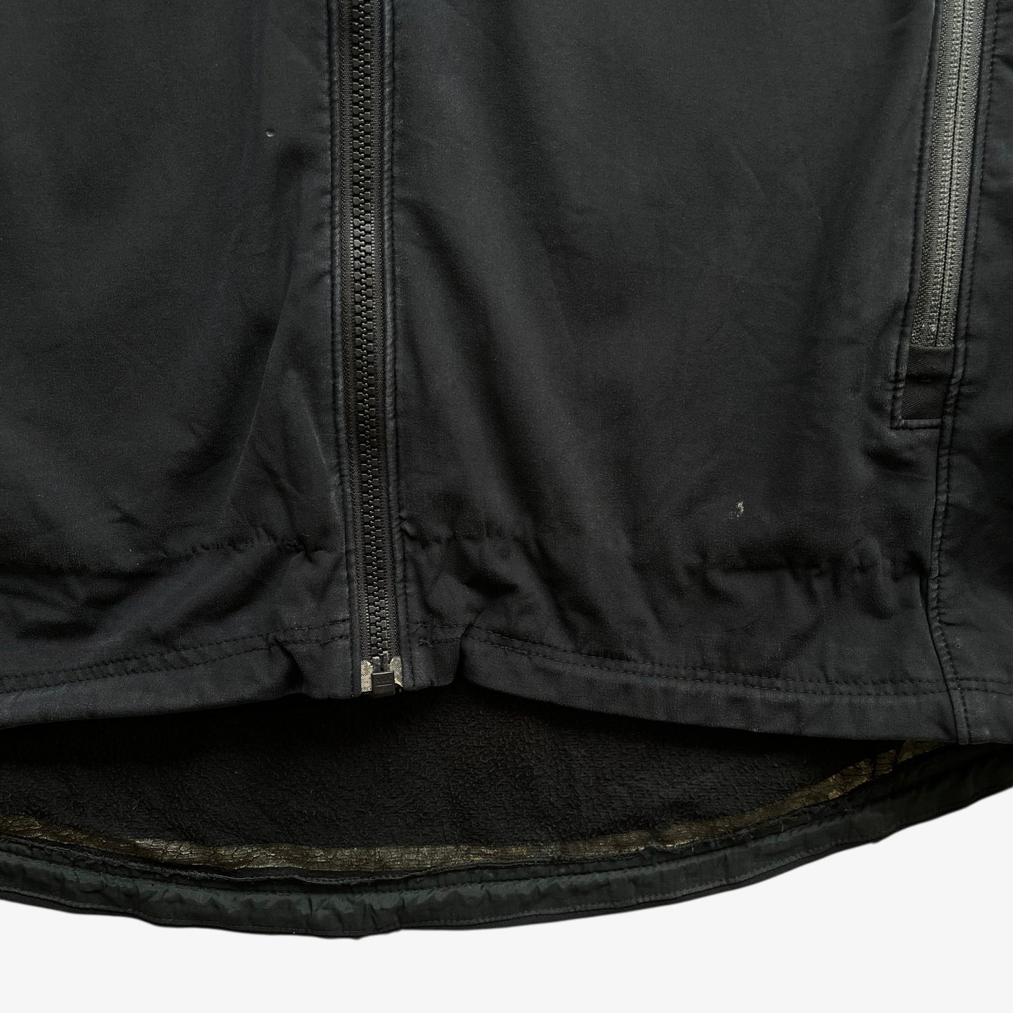 Patina on men's vintage Y2K Arcteryx Polartec black hooded utility jacket.
