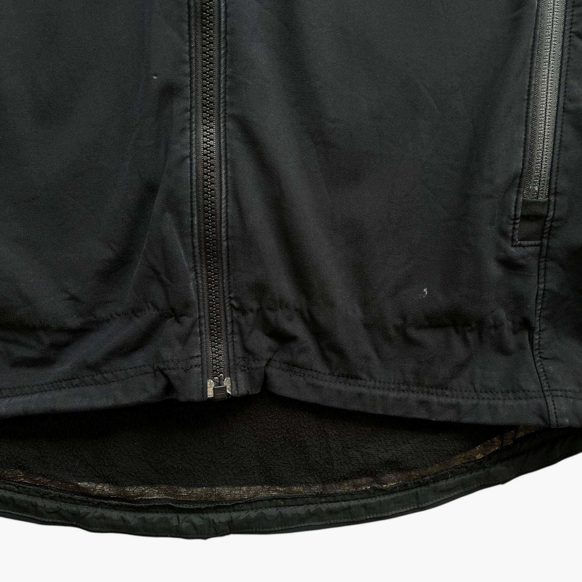 Patina on men's vintage Y2K Arcteryx Polartec black hooded utility jacket.